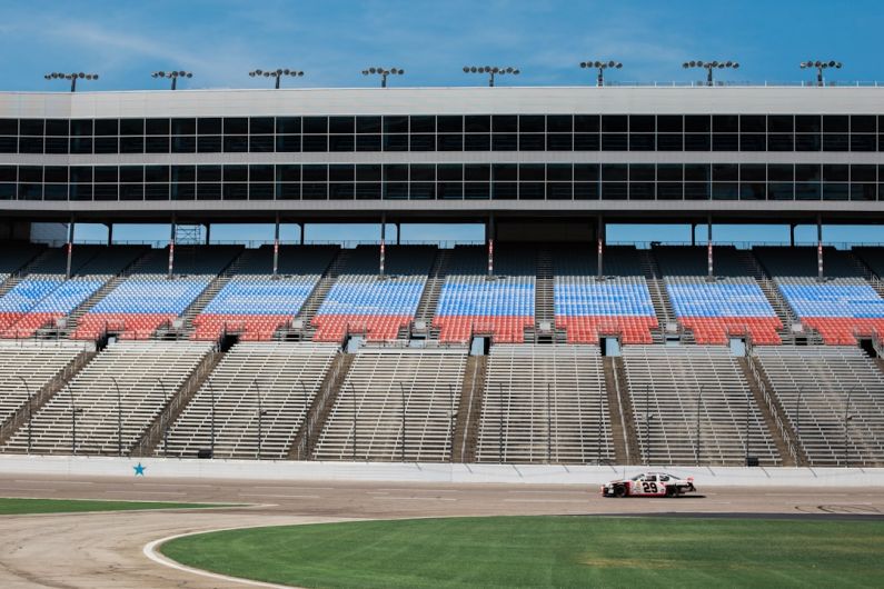 Camaro Racing Influence - aerial photography of car on stadium under clear blue sky