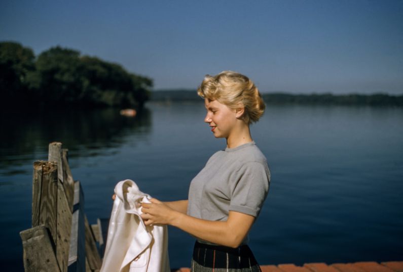 Camaro Vintage Mods - woman holding white textile standing beside body of water