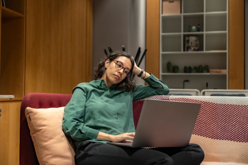 Camaro Connectivity - a woman sitting on a couch using a laptop computer
