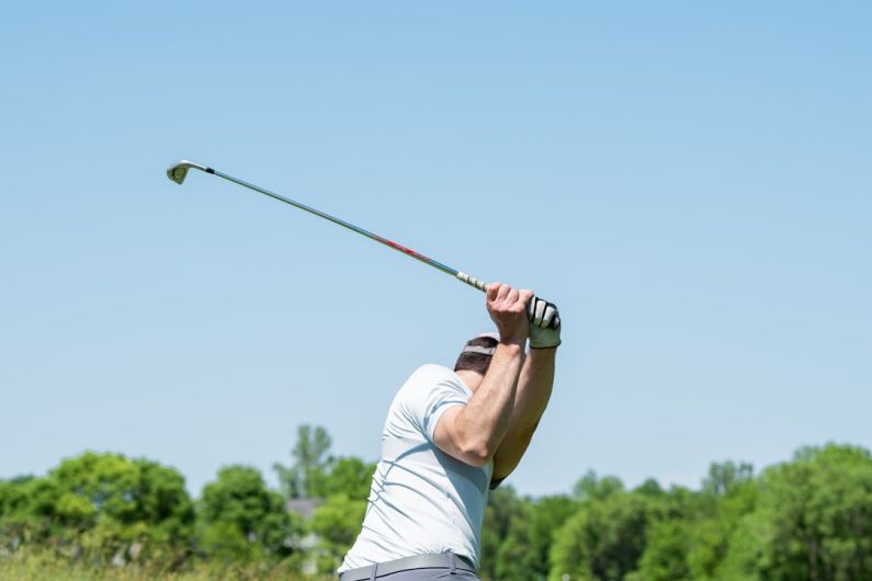 Camaro Club - man in white tank top and white shorts playing golf during daytime